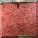 DR12. Wool area rug in shades of red. Measures approx 12'4” x 15'5” 